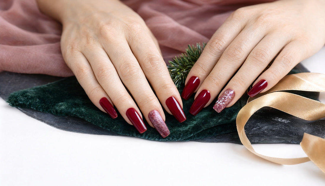 Christmas nail set with red chrome, glitter and a white snowflake on dark green velvet