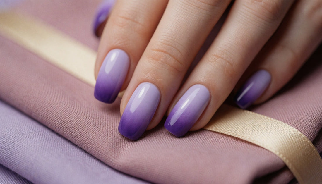 Hand with a smooth lavender-to-deep-purple ombré gradient nail design